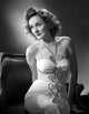 Constance Moore photo print in tube dress sitting and bending
