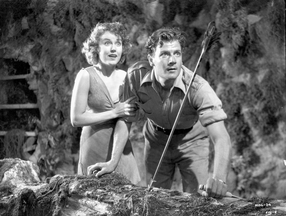 Black and white photo print of a dangerous woman holding her man's shoulder in a cave.