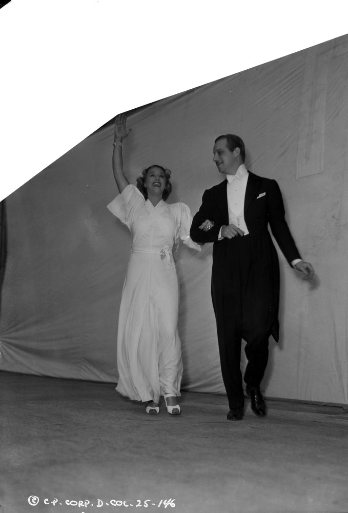 Grace Moore Holding a Man Dancing Photo Print showcasing elegance and joy.
