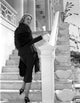 Patricia Neal photo print featuring her standing on stairs in a long sleeve outfit.