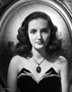 Portrait photo print of Joan wearing a strapless dress with matching necklace.