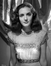 Joan Newton wearing a glittering cap-sleeve dress photo print