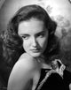 Joan Newton wearing a strapless black dress in a portrait photo print.
