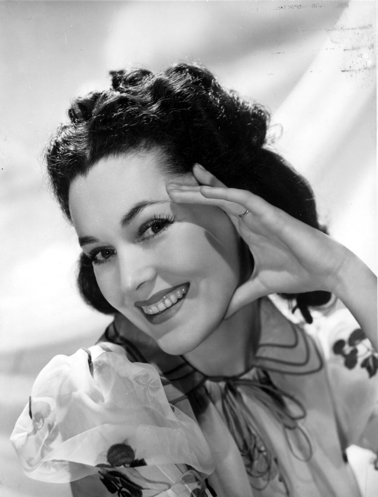 Maureen O'Sullivan smiling in a white printed dress photo print