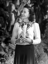 Maureen O'Sullivan smiling in an embroidered dress photo print.