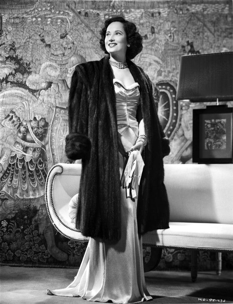 Merle Oberon standing photo print showcasing classic Hollywood glamour.