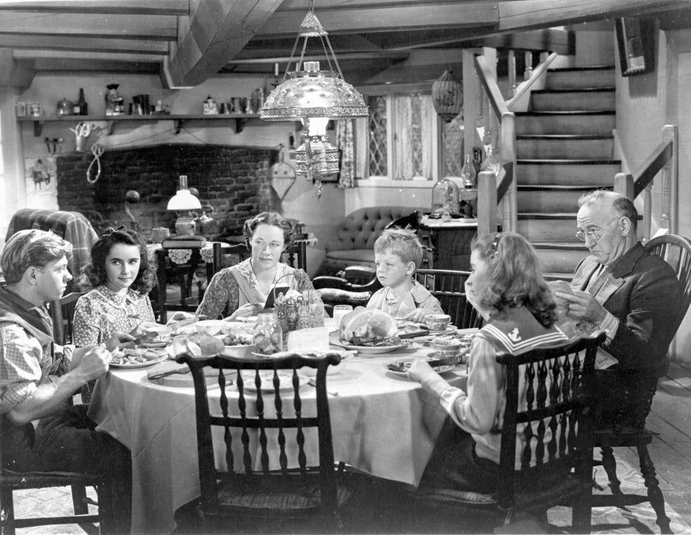 National Velvet Family Having Conversation at Dining Table Photo Print
