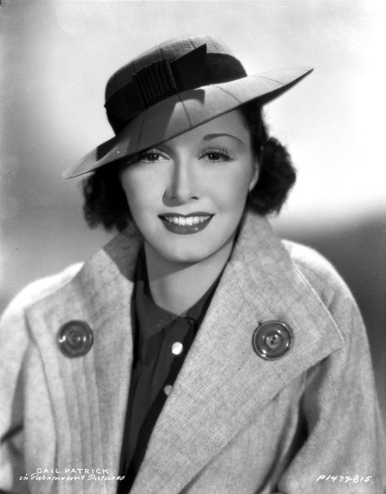 Gail Patrick smiling in a coat and hat photo print.