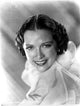 Eleanor Powell smiling in ruffled top photo print