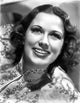 Eleanor Powell smiling in a sequin top, vintage photo print.