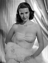 Mala Powers posed elegantly in a white strapless dress with a necklace