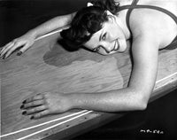 Mala Powers leaning against a rustic wooden backdrop photo print.