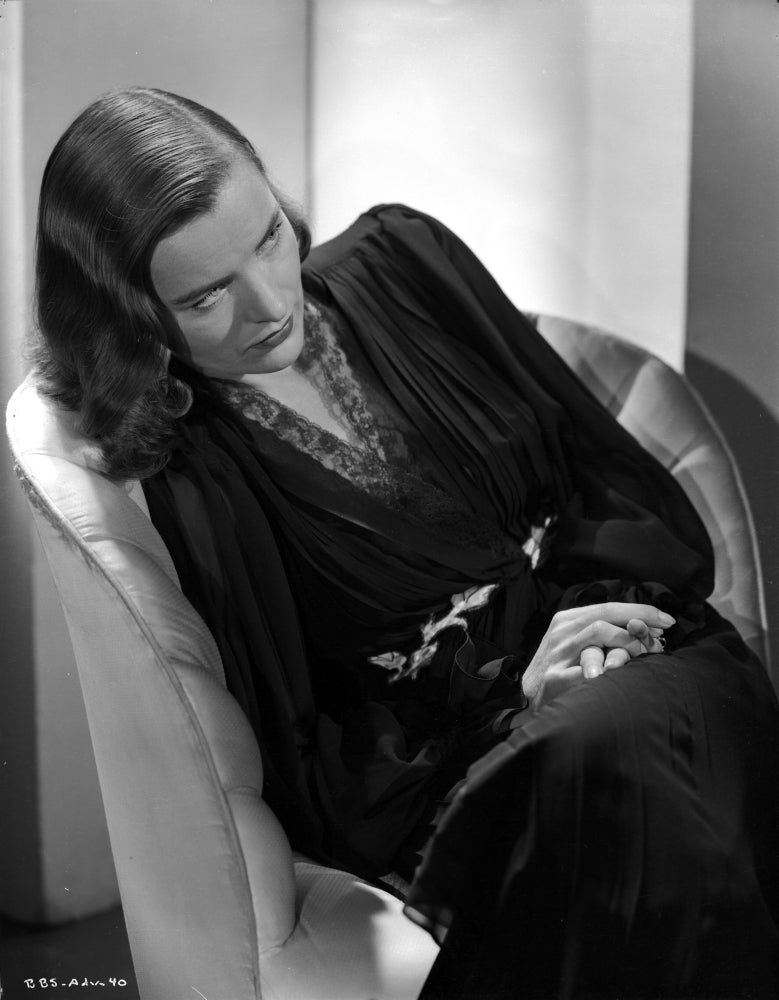 Ella Raines seated in black and white photo print