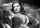 Ella Raines sitting in a ruffled dress photo print