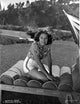 Martha Raye sitting on a couch in a printed top photo print.