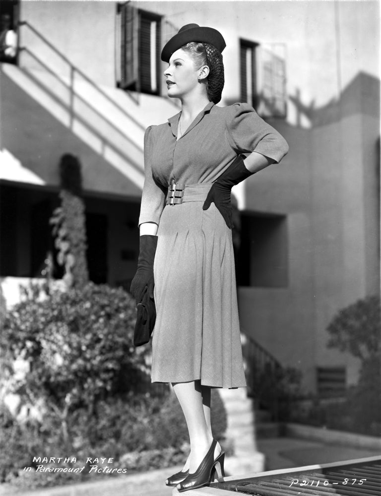Martha Raye wearing a trench coat in a black and white photo print