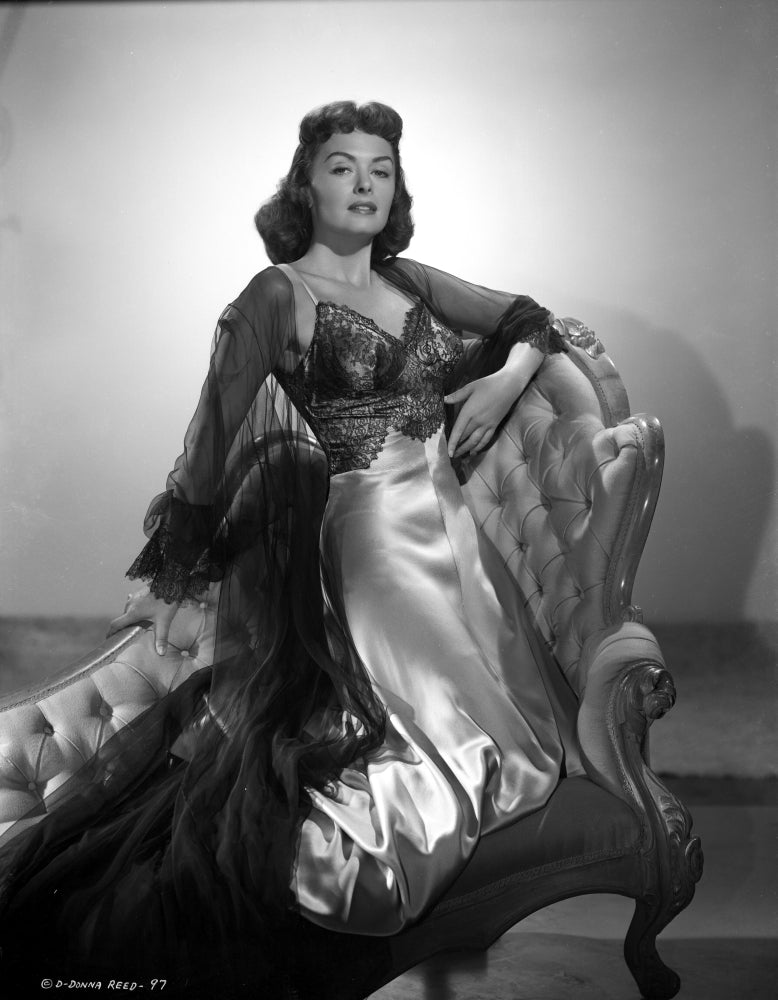Donna Reed kneeling on a couch in black and white photo print