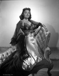 Donna Reed kneeling on a couch in black and white photo print