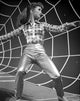 Debbie Reynolds portrait in checkered top on spider web background