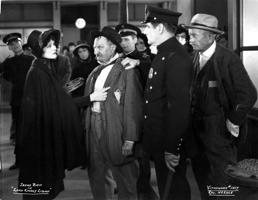 Irene Rich in black dress engaging in conversation - photo print
