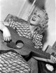 A Portrait of Lyda Roberti Playing a Guitar Photo Print