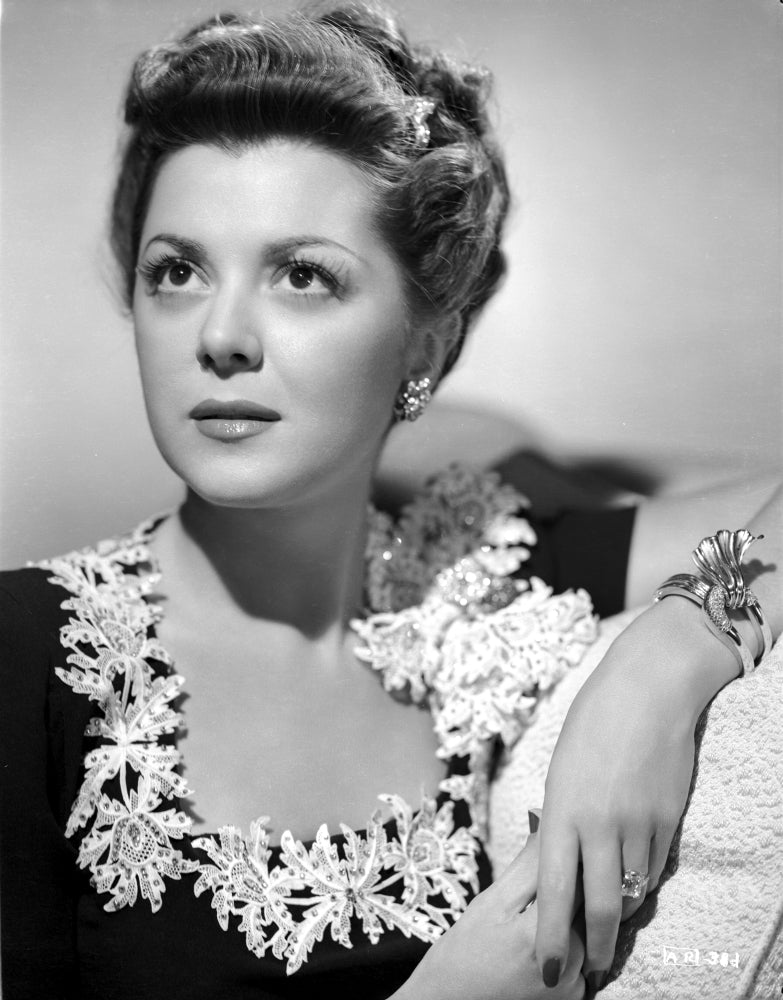 Ann Rutherford wearing a black dress with floral design on neckline photo print.