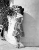 Ann Rutherford leaning on the wall in a dress photo print.