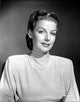 Photo print of Ann Sheridan in tunic with beaded necklace