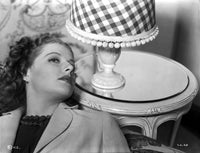 Ann Sheridan leaning on a chair near a lamp shade photo print