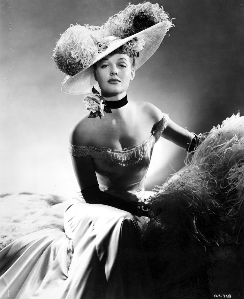 Ann Sheridan wearing an elegant gown and big hat photo print.