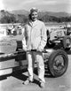 Ann Sheridan standing next to a classic race car photo print