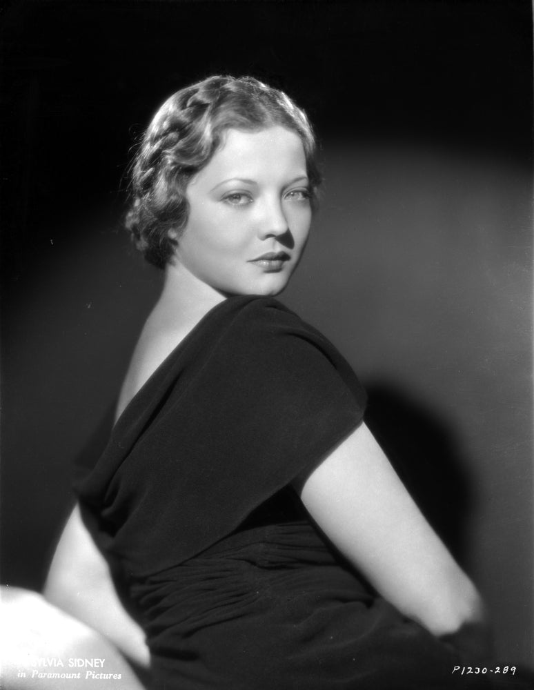 Sylvia Sidney posed in a black dress photo print.