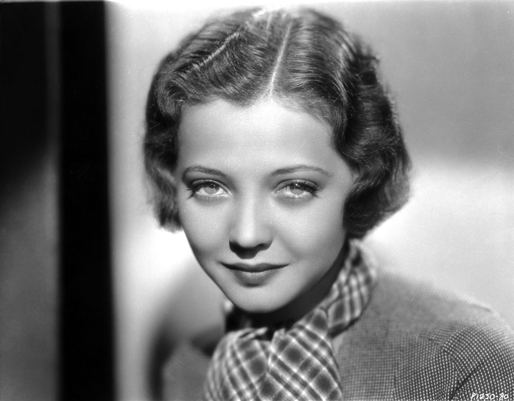Sylvia Sidney photo print in printed scarf and textured blouse.