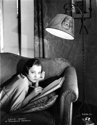 Sylvia Sidney lying on couch while writing photo print