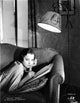 Sylvia Sidney lying on couch while writing photo print