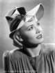 Penny Singleton looking up in a ribbon hat close-up portrait photo print.