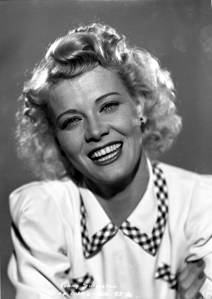 Close-up portrait photo print of Penny Singleton smiling in a white blouse.