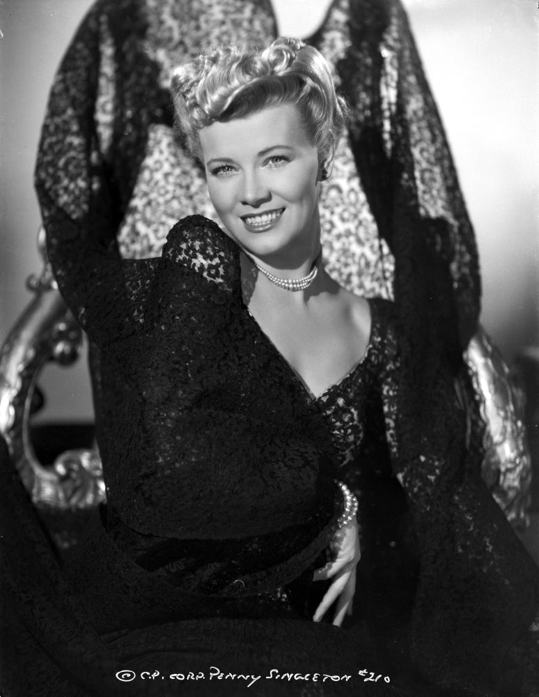 Penny Singleton smiling in a black floral dress portrait photo print.