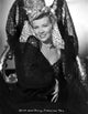 Penny Singleton smiling in a black floral dress portrait photo print.