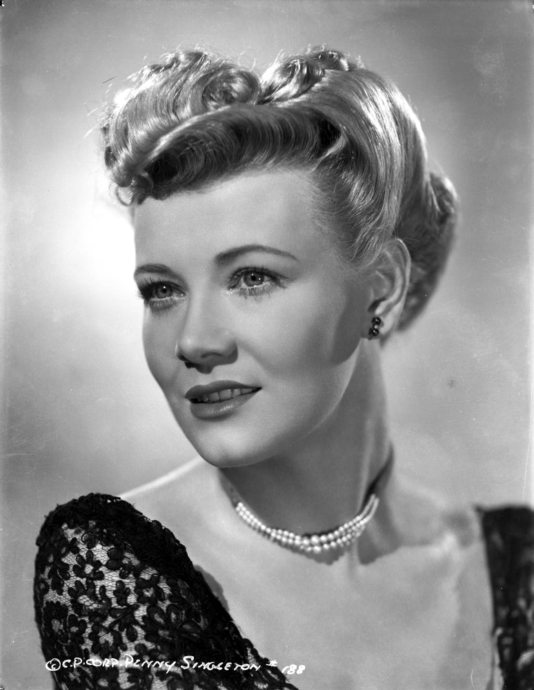 Close up portrait photo print of Penny Singleton smiling in a black floral dress.