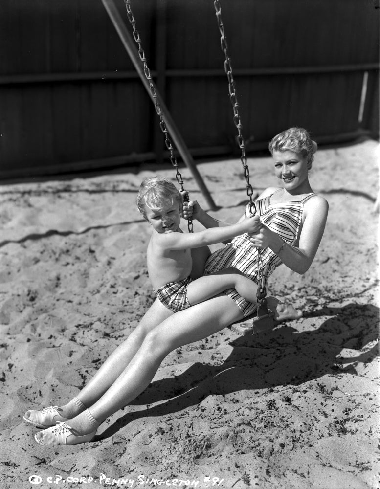 Penny Singleton swing riding with her son at the beach photo print.