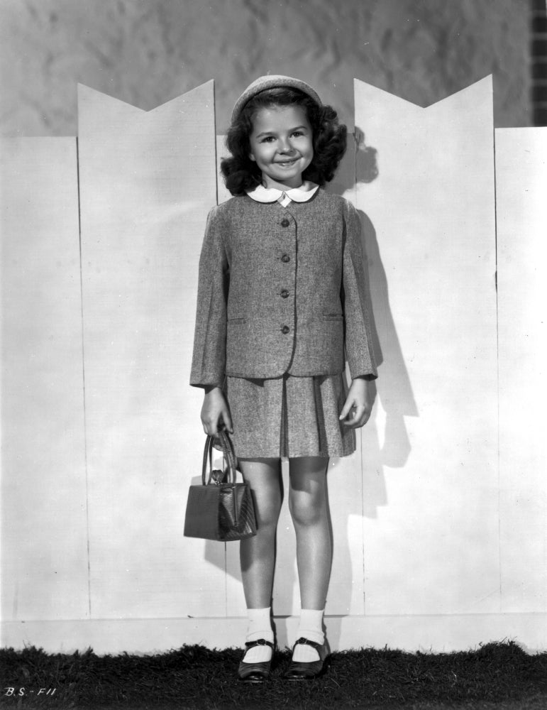 Grayscale photo print of Beverly Simmons in school uniform with bag