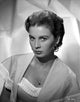 Jean Simmons portrait photo print in white knitted top and silk muffler coat.