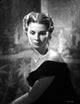 Jean Simmons seated in elegant black velvet off-shoulder dress photo print.