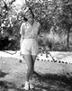 Jean Simmons posed in white striped shirt and white pants photo print