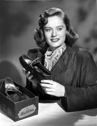 Alexis Smith classic portrait photo print, smiling while holding a shoe.