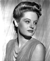 Alexis Smith photo print looking to the left wearing a beaded necklace.