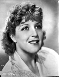 Betty Stockfeld smiling and looking up in a black and white portrait photo print.