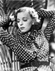 Margaret Sullivan in polka dot outfit, photo print raising both hands.