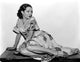 Lupe Velez seated in a classic floral dress photo print